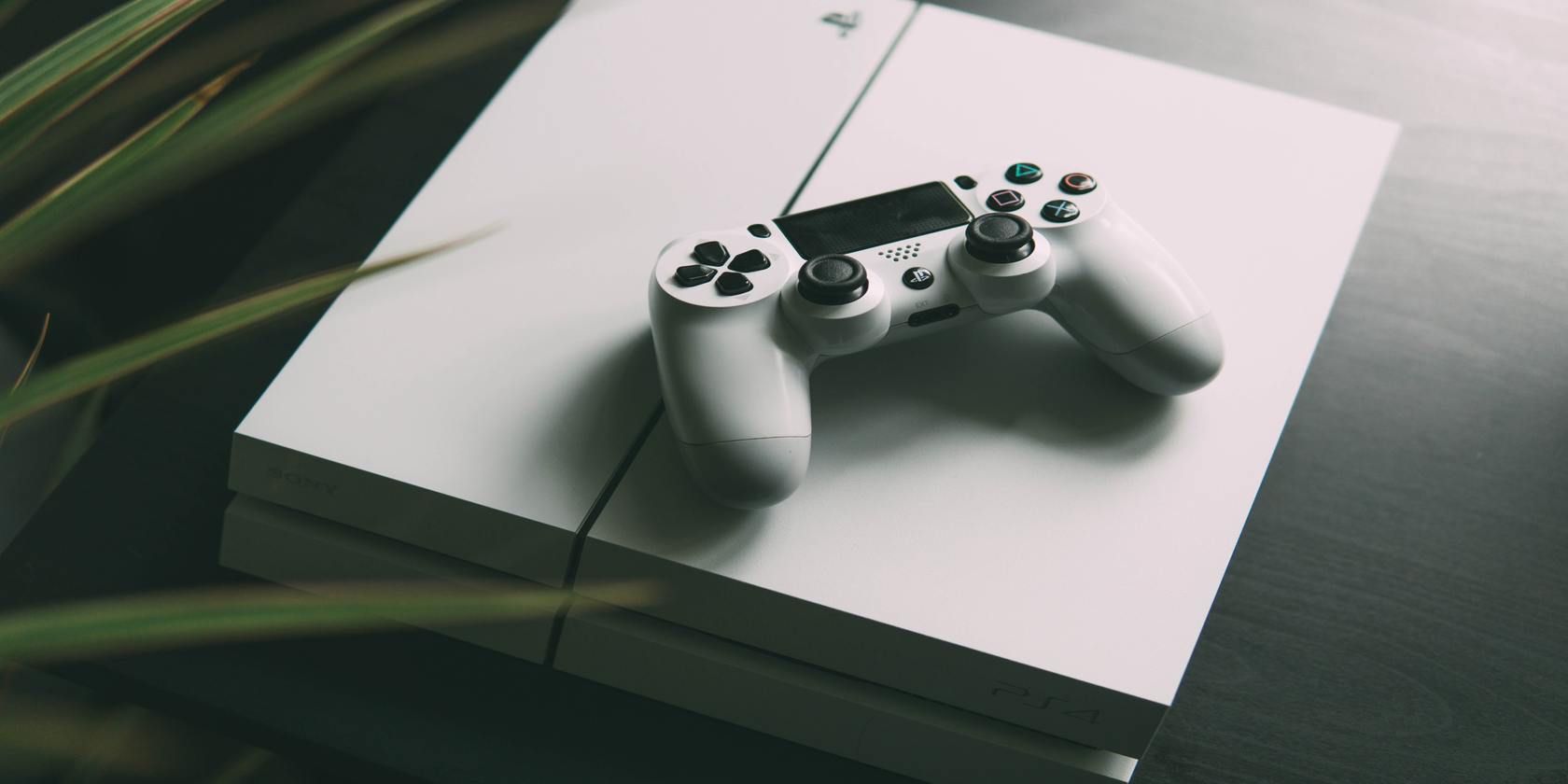 white ps4 and dualshock controller