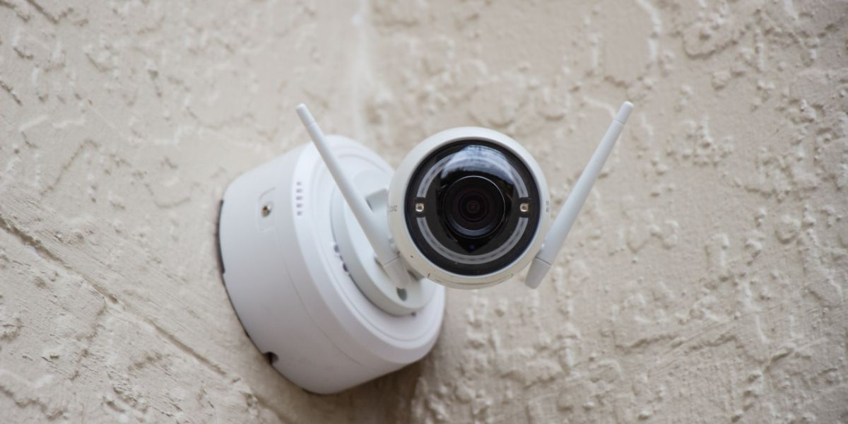 Security camera on beige stucco wall