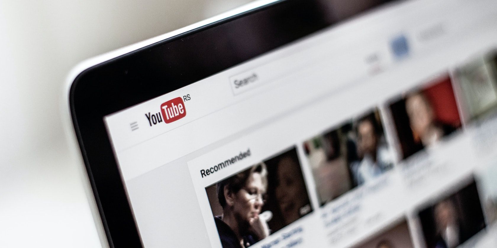 A photograph of a laptop screen displaying YouTube