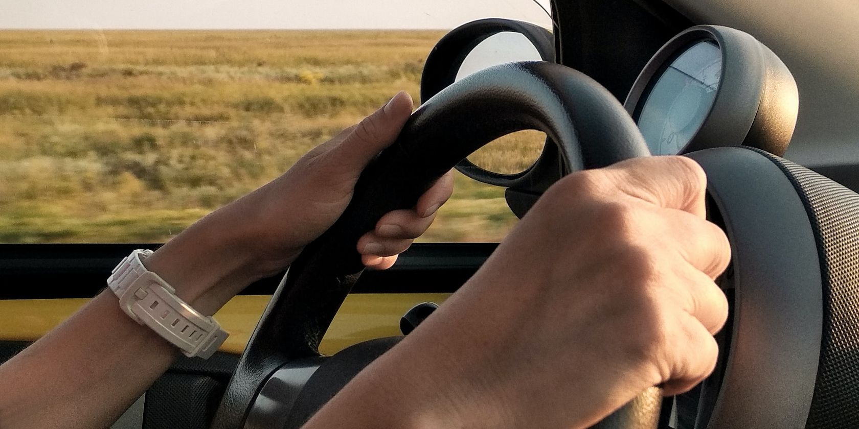 Female Hands on Steering Wheel While Driving