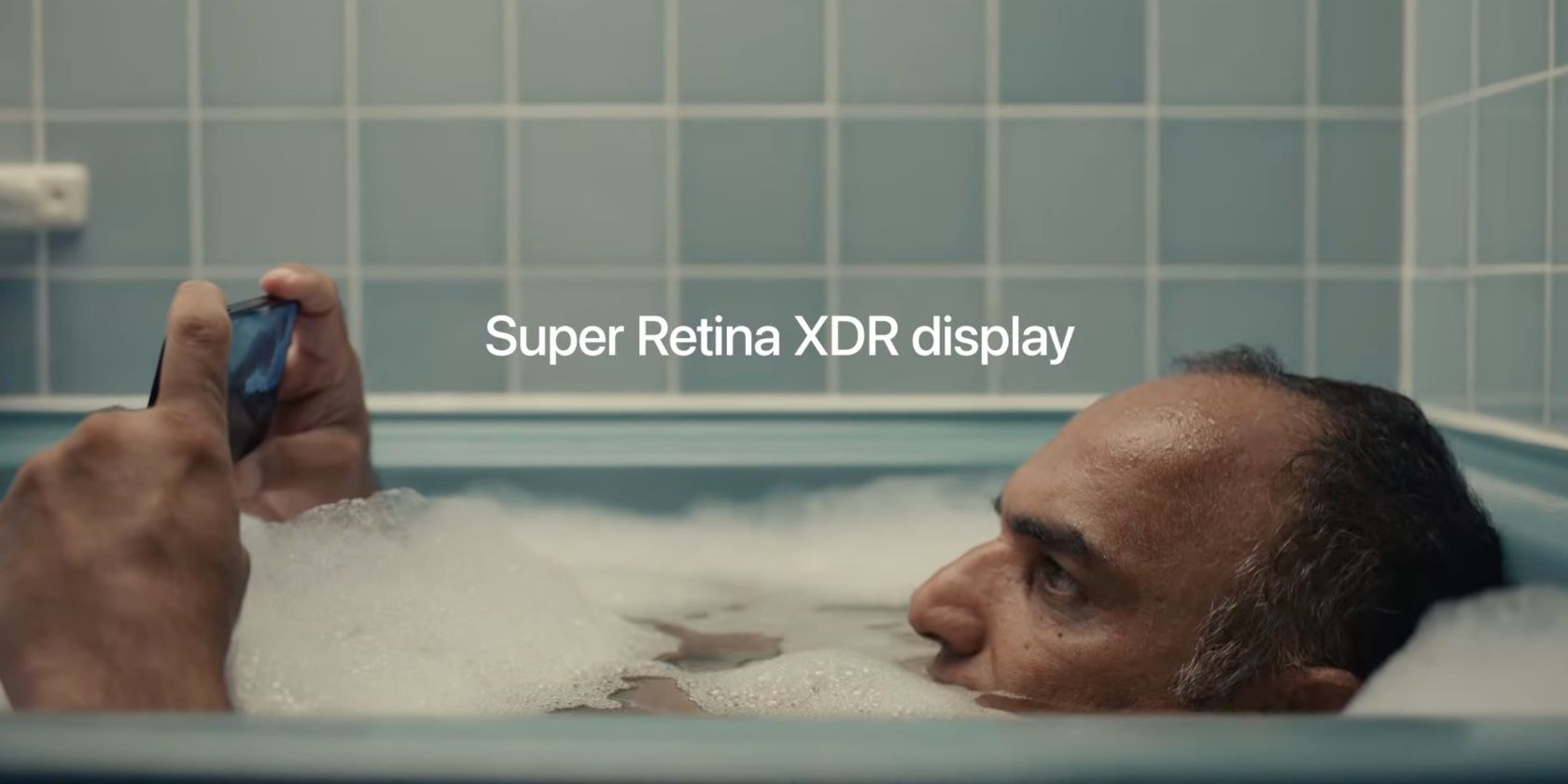 A still from Apple's iPhone 12 ad promoting the Super Retina XDR Display technology