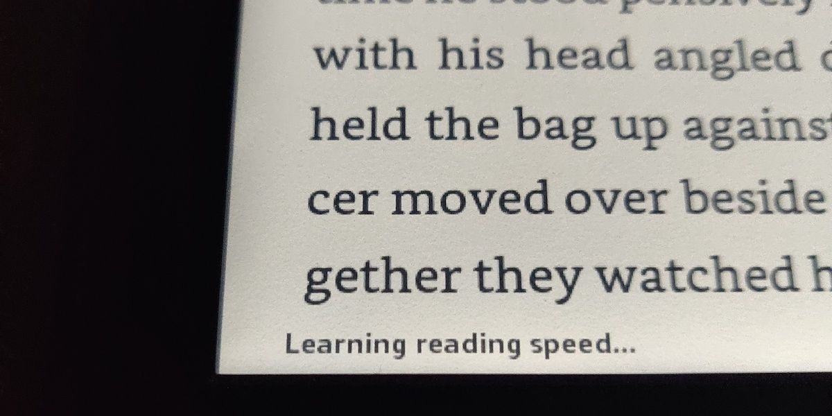 A Kindle with text and "Learning reading speed..." in the bottom of the screen