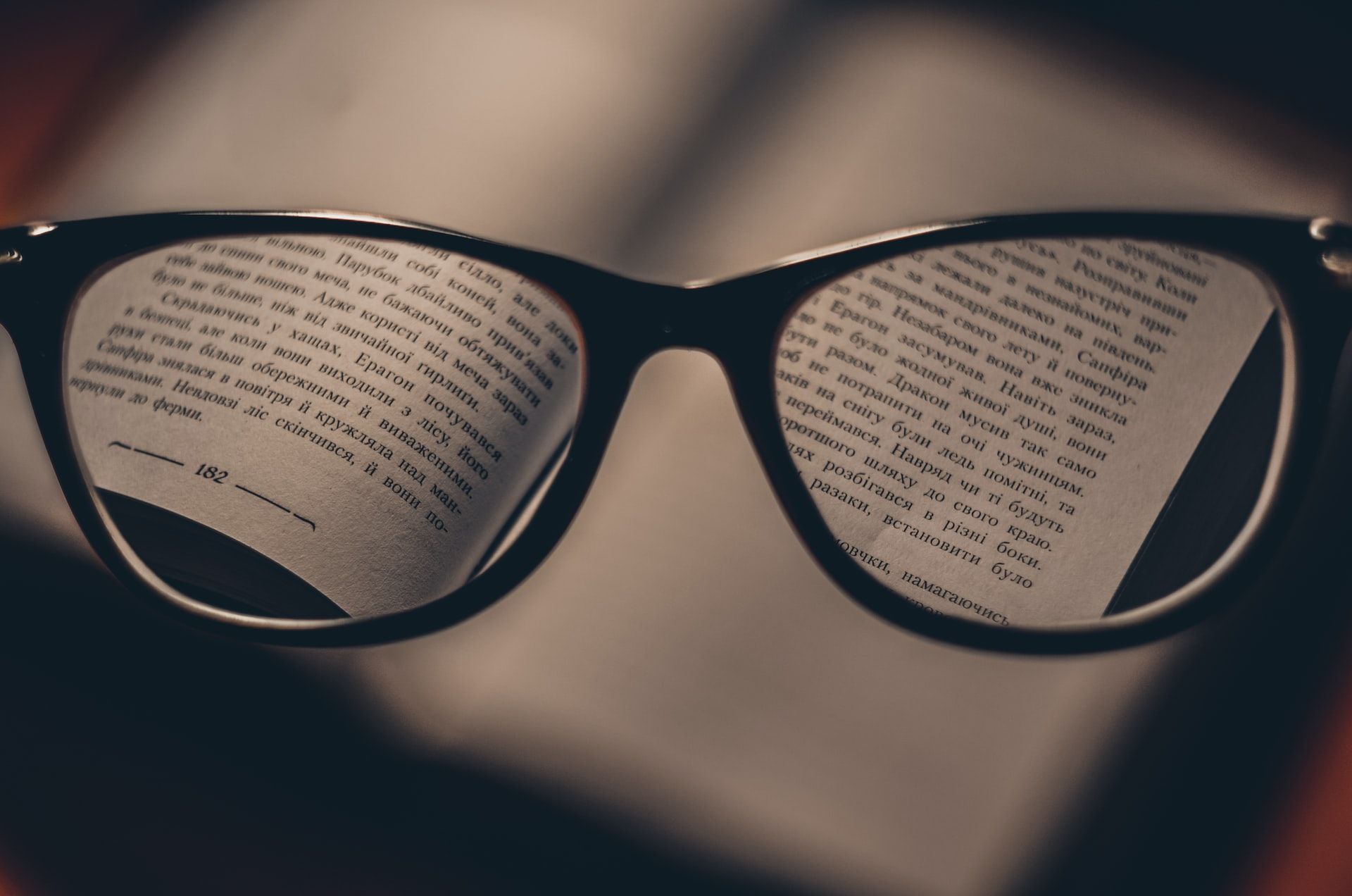 Looking at a book through reading glasses
