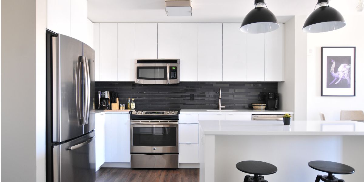 Black and white kitchen with stainless steel appliances