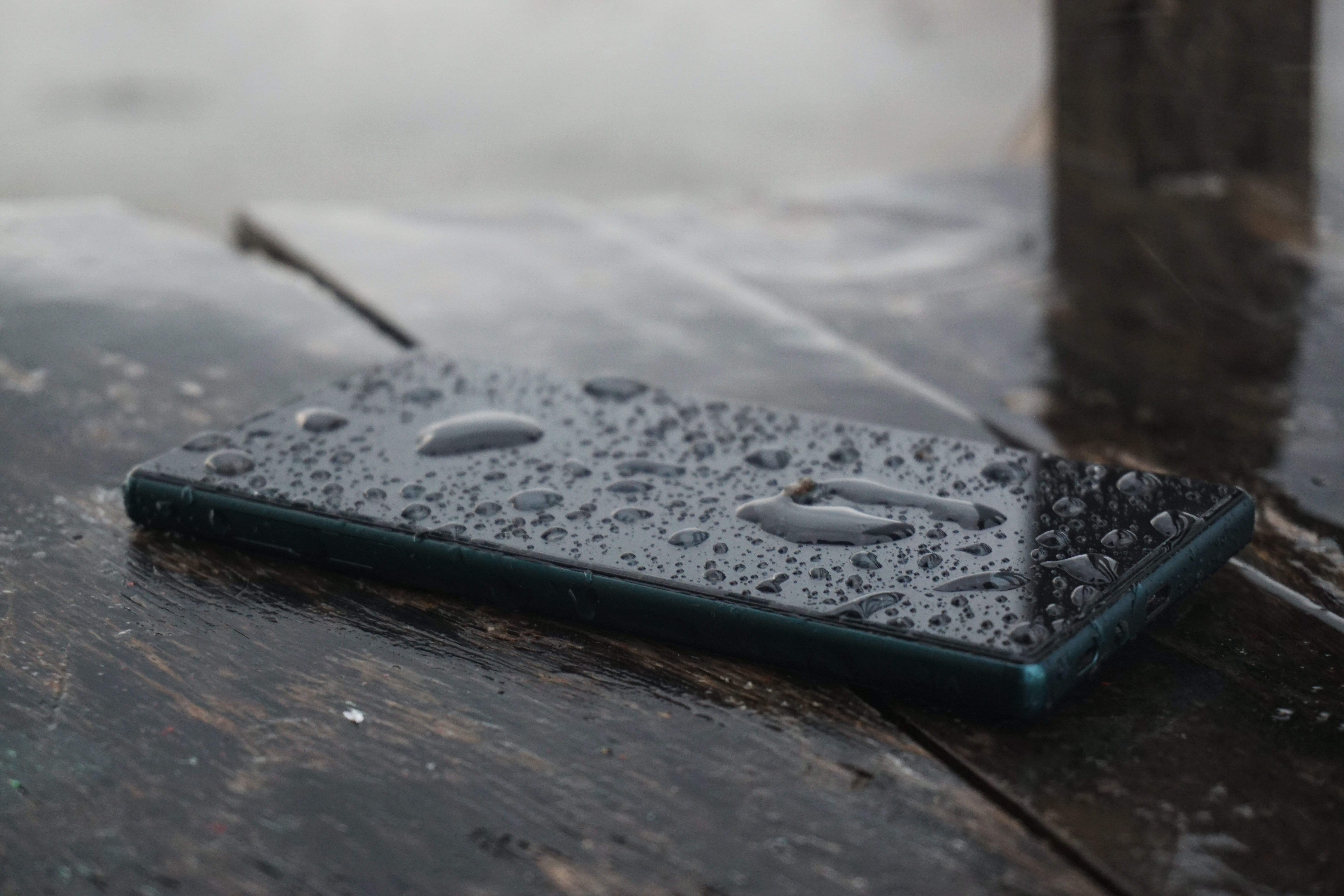 A smartphone covered in rain