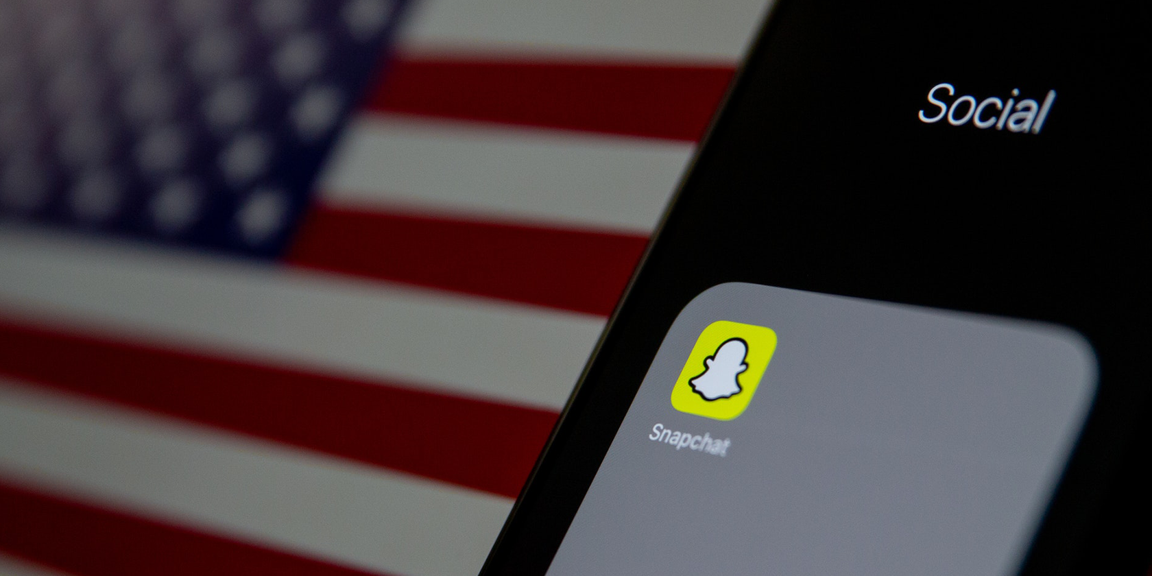 Snapchat app icon on iPhone in front of the US flag