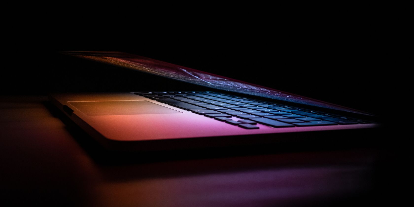 An almost-shut laptop in the dark