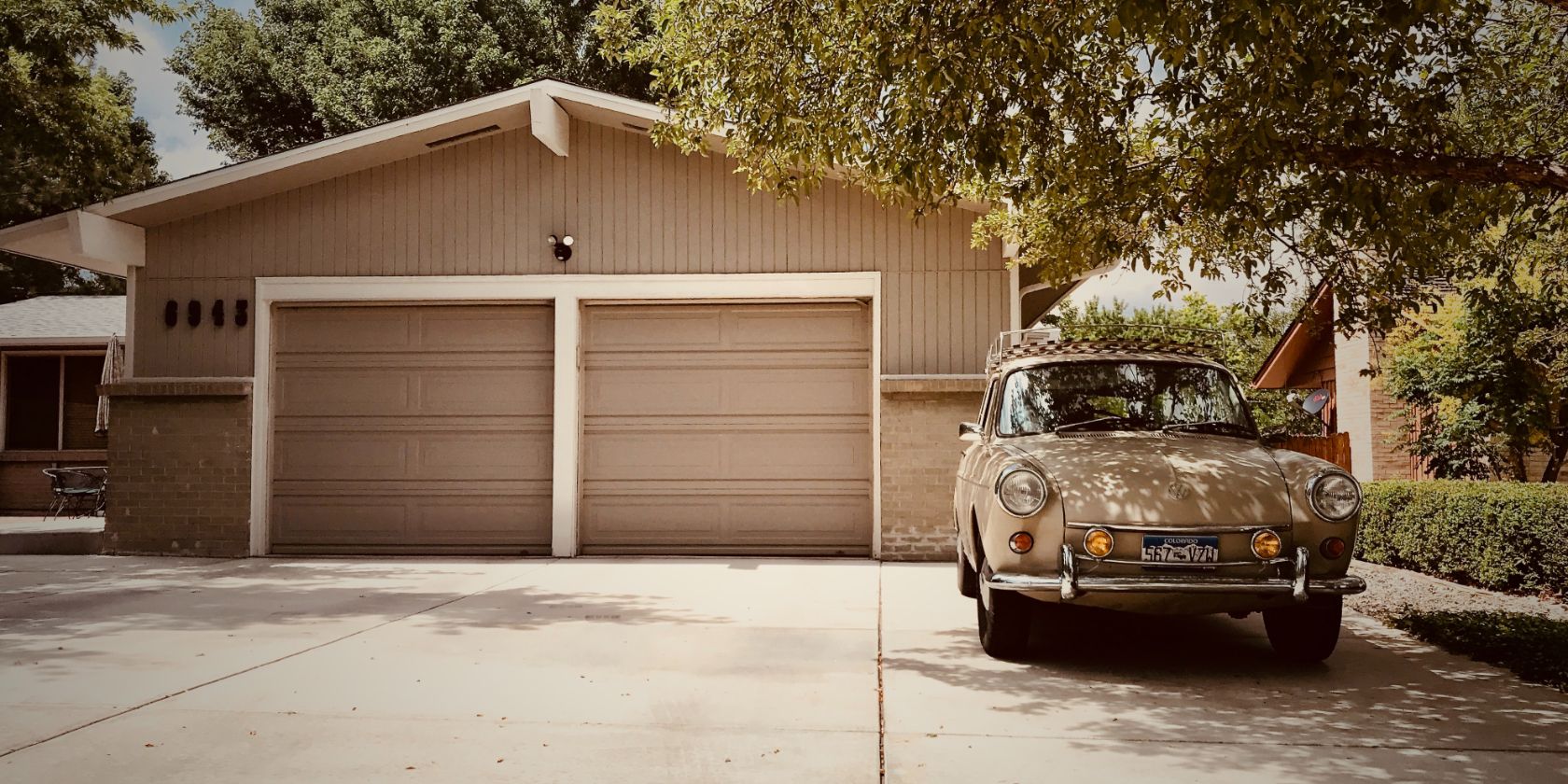 Brown garage Door With Old Car in Front