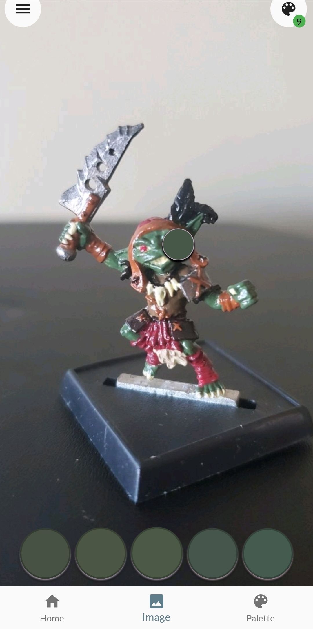 A photo of a goblin mini in Miniature Painter Pro, with the eyedropper selecting colors
