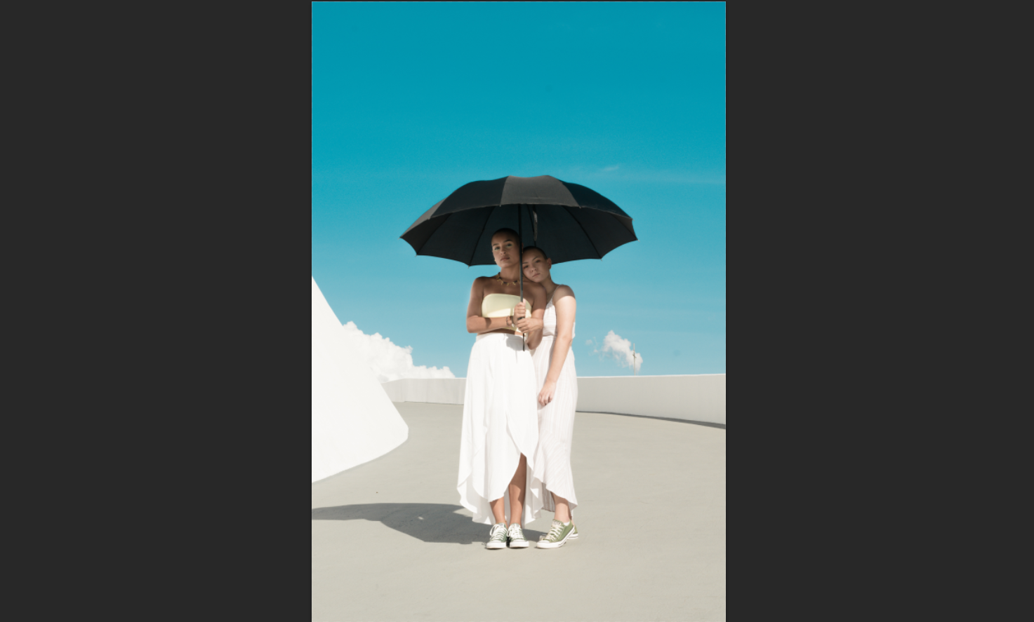 two women under umbrella