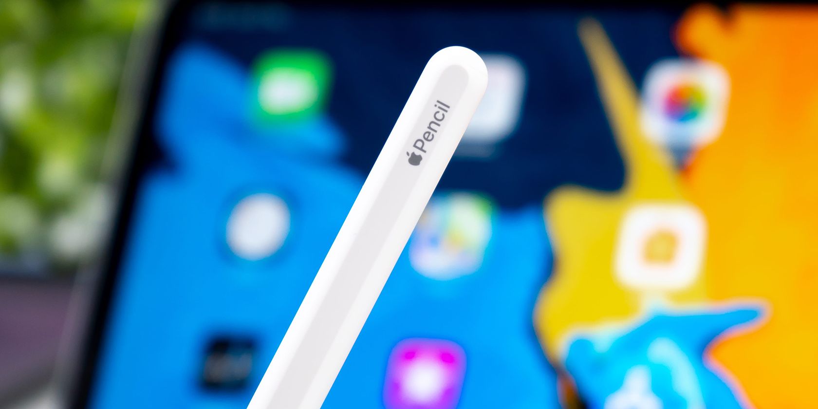 Apple Pencil in front of iPad.