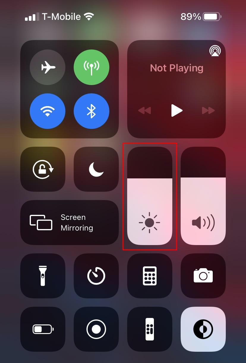 iPhone control center with brightness slider highlighted
