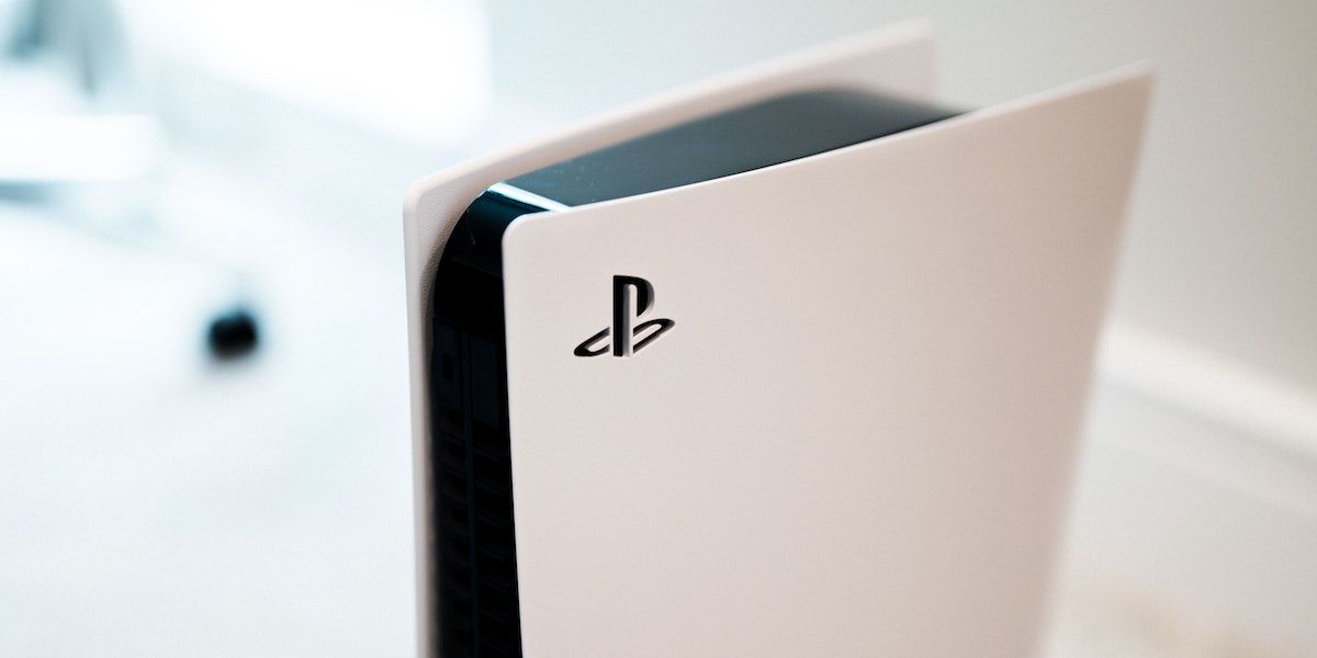 A PS5 standing up with the image focused on the Sony logo.