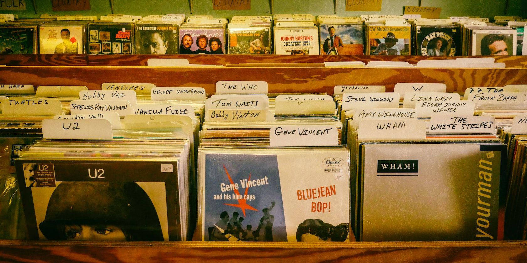 A photograph showing racks of records grouped by artist