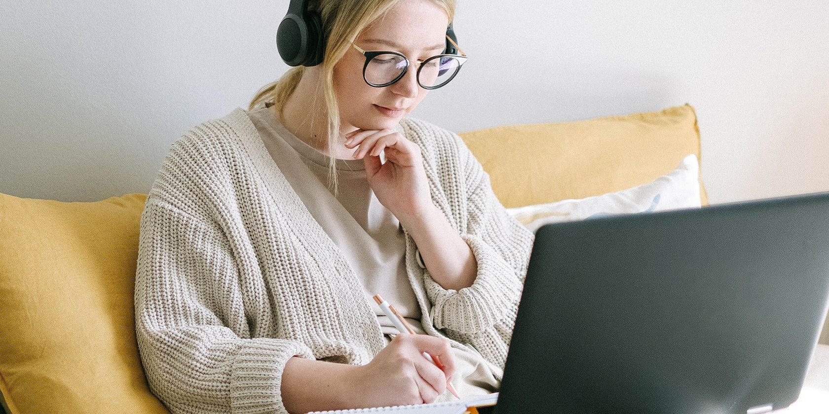 Woman with headphones on laptop