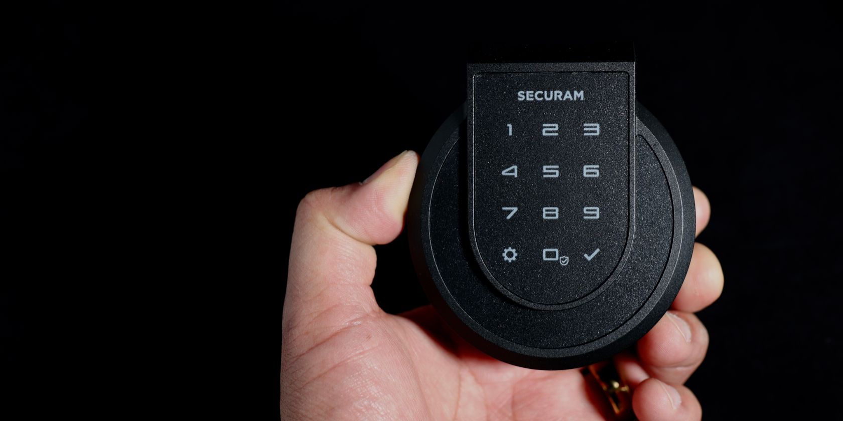 Securam Smart Lock In Hand Black Background
