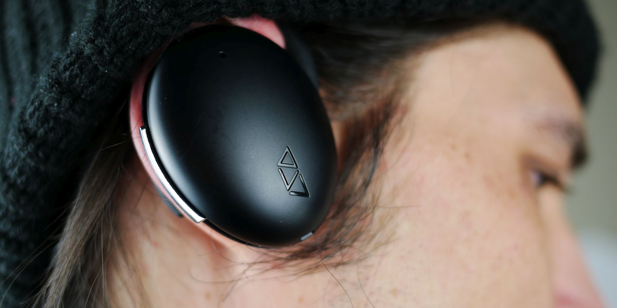 Man wearing the Waverly Labs Ambassador Interpreter on his right ear.
