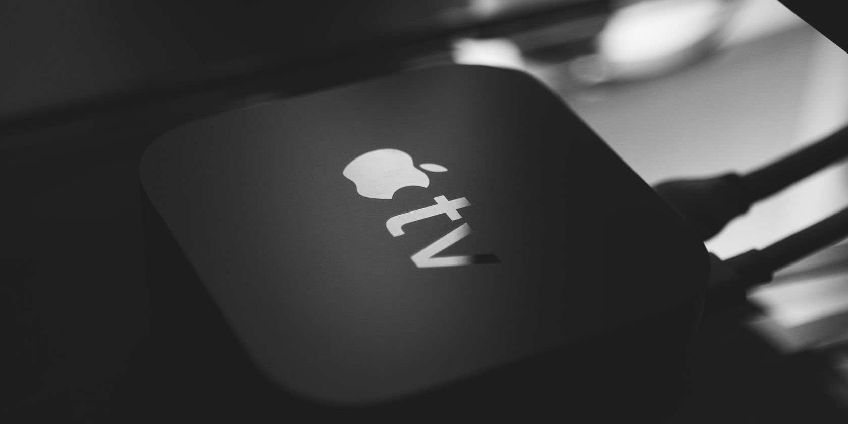 Apple TV box on a tabletop.