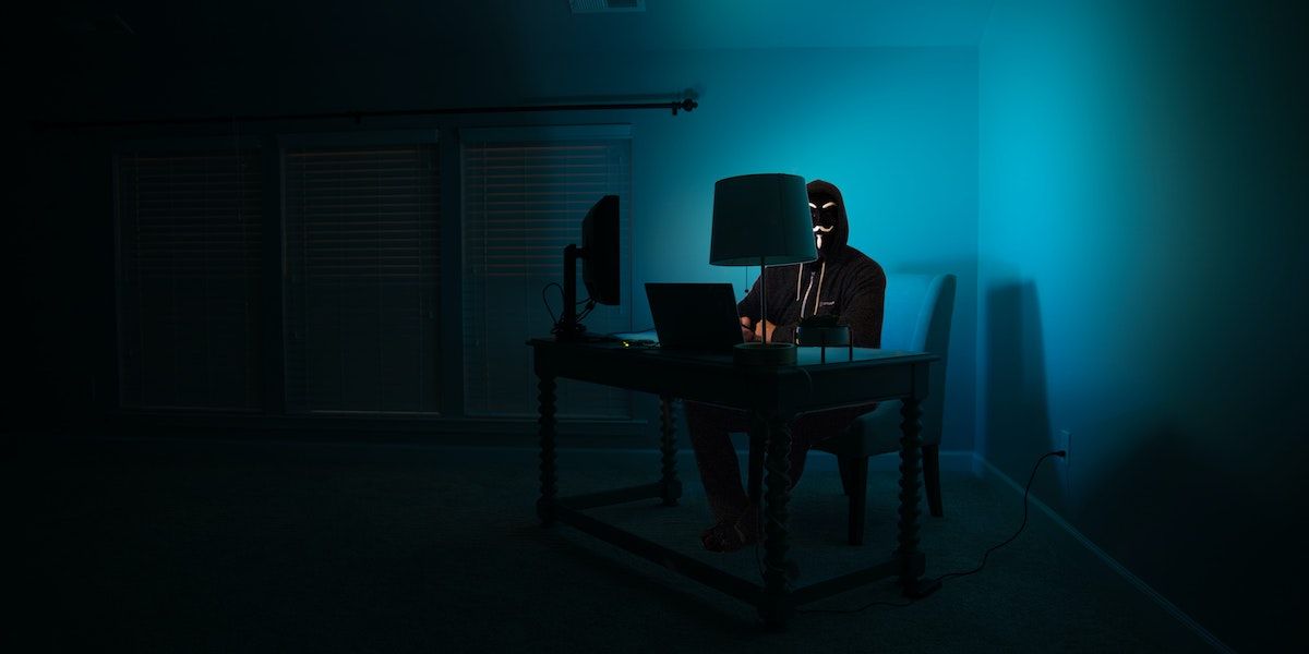 A Cybercriminal Sitting With A Laptop