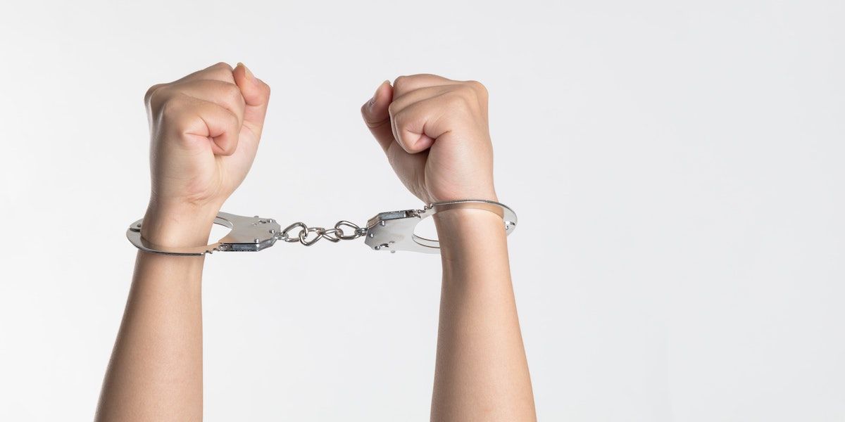 two hands in handcuffs