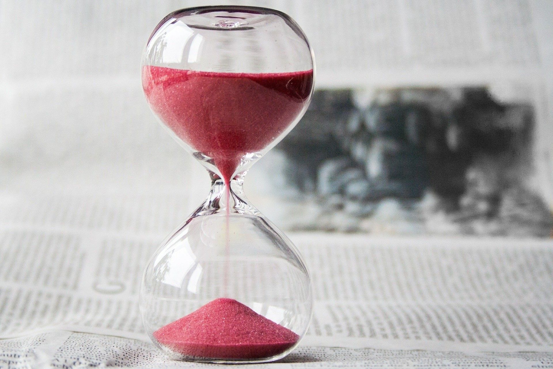 an hourglass with red sand