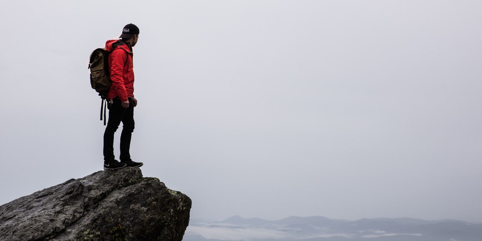 man standing on top of rock