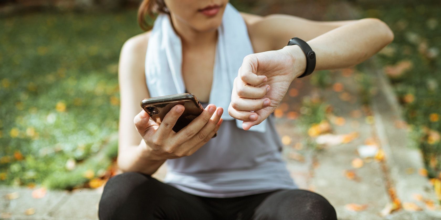 A person using their phone and watch to track their exercise.