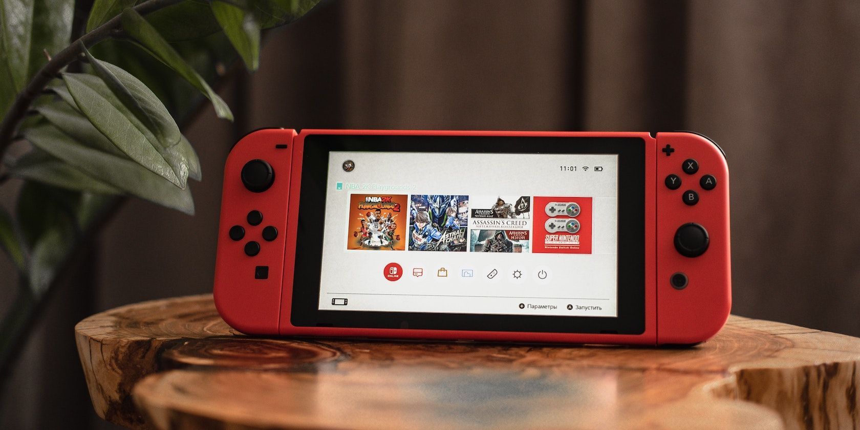 A photograph of a Nintendo Switch console on a wooden table