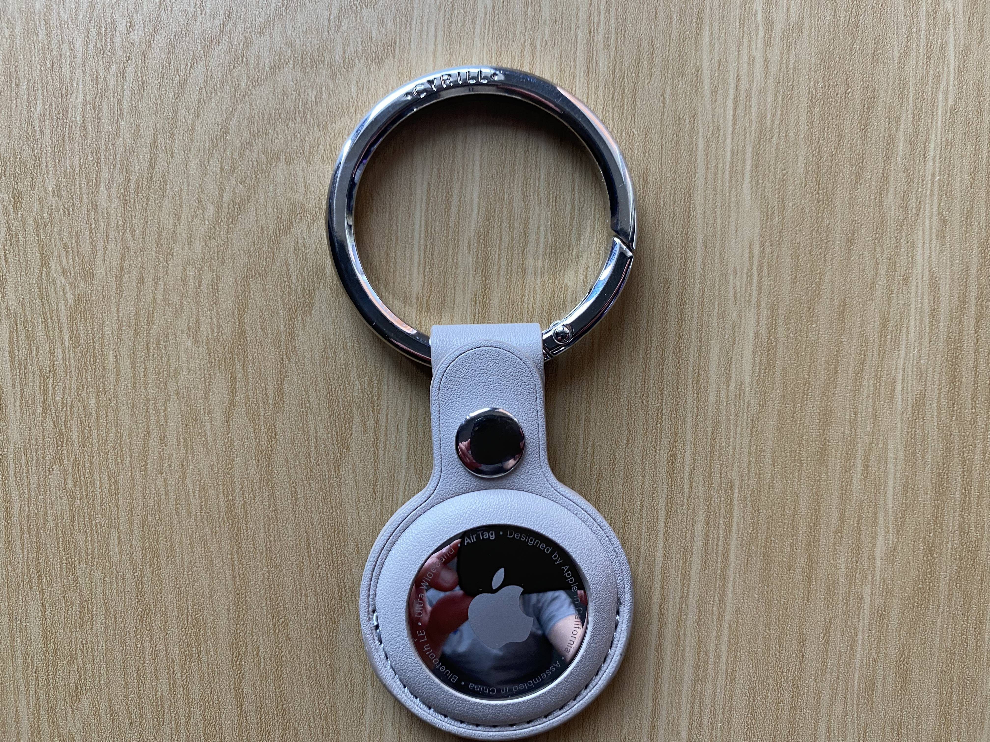 An AirTag in a third-party leather keychain