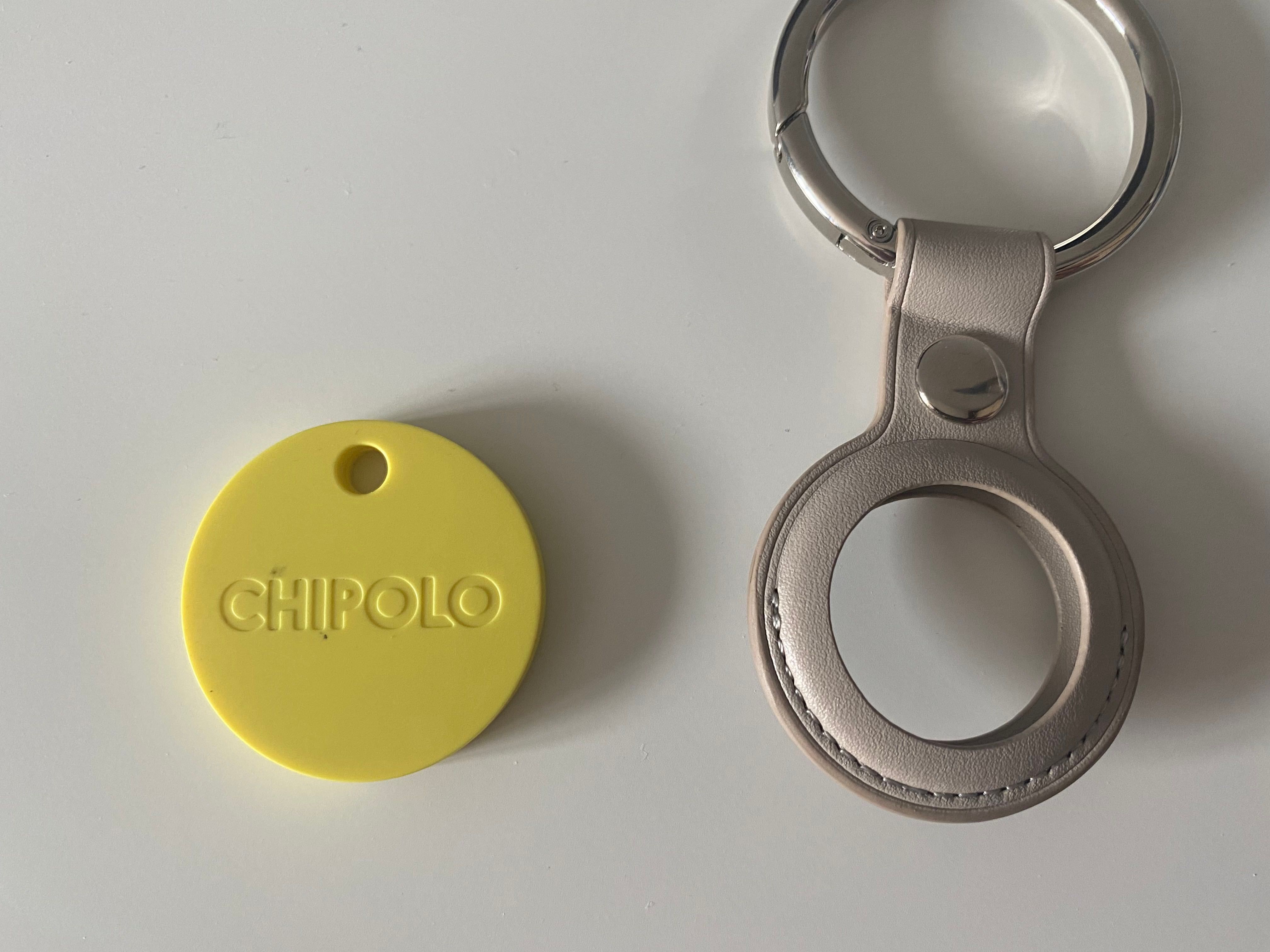 A Chipolo with the keychain hole next to a keychain accessory for an AirTag