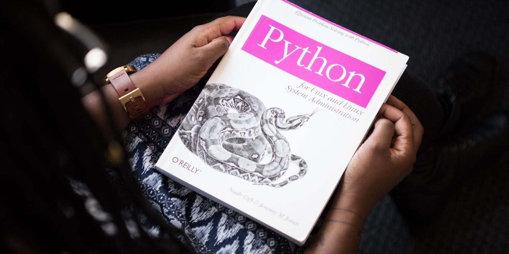 Hand holding a Python tutorial manual