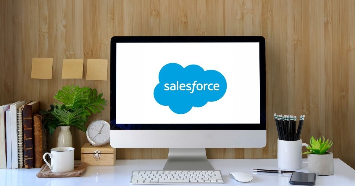 Desktop on desk with Salesforce logo on screen