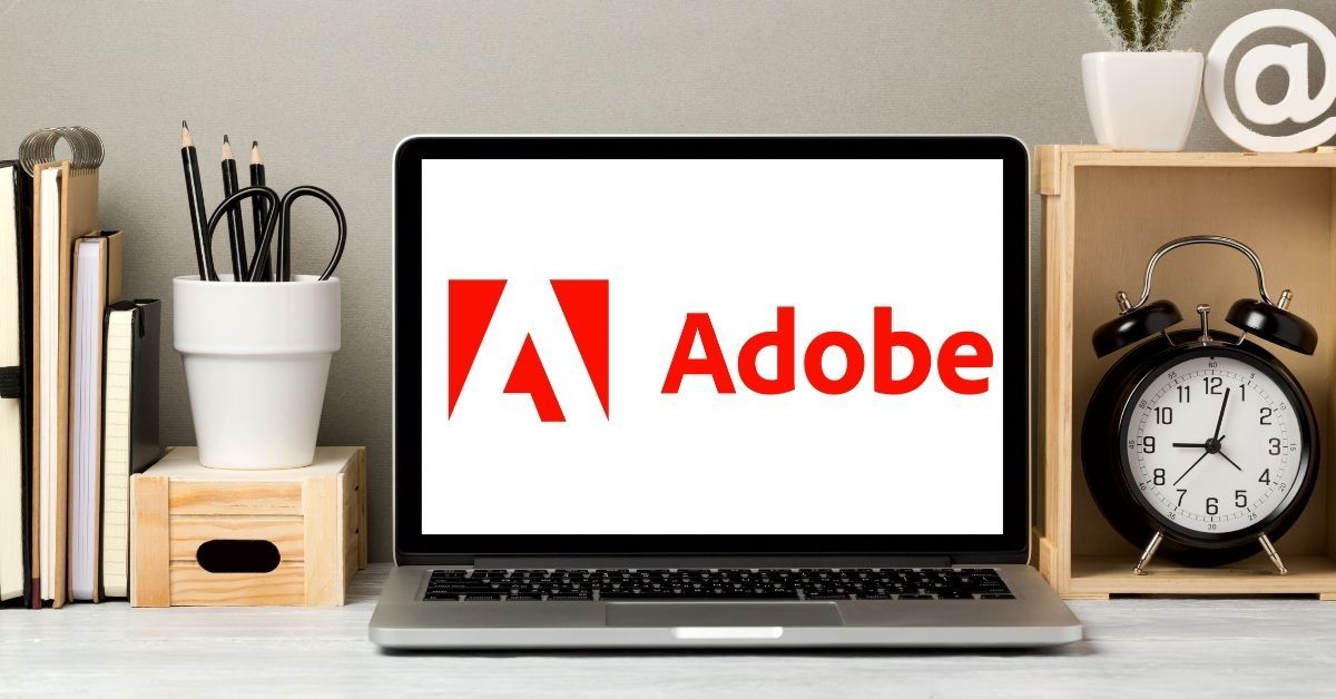 Laptop on desk with Adobe logo on screen