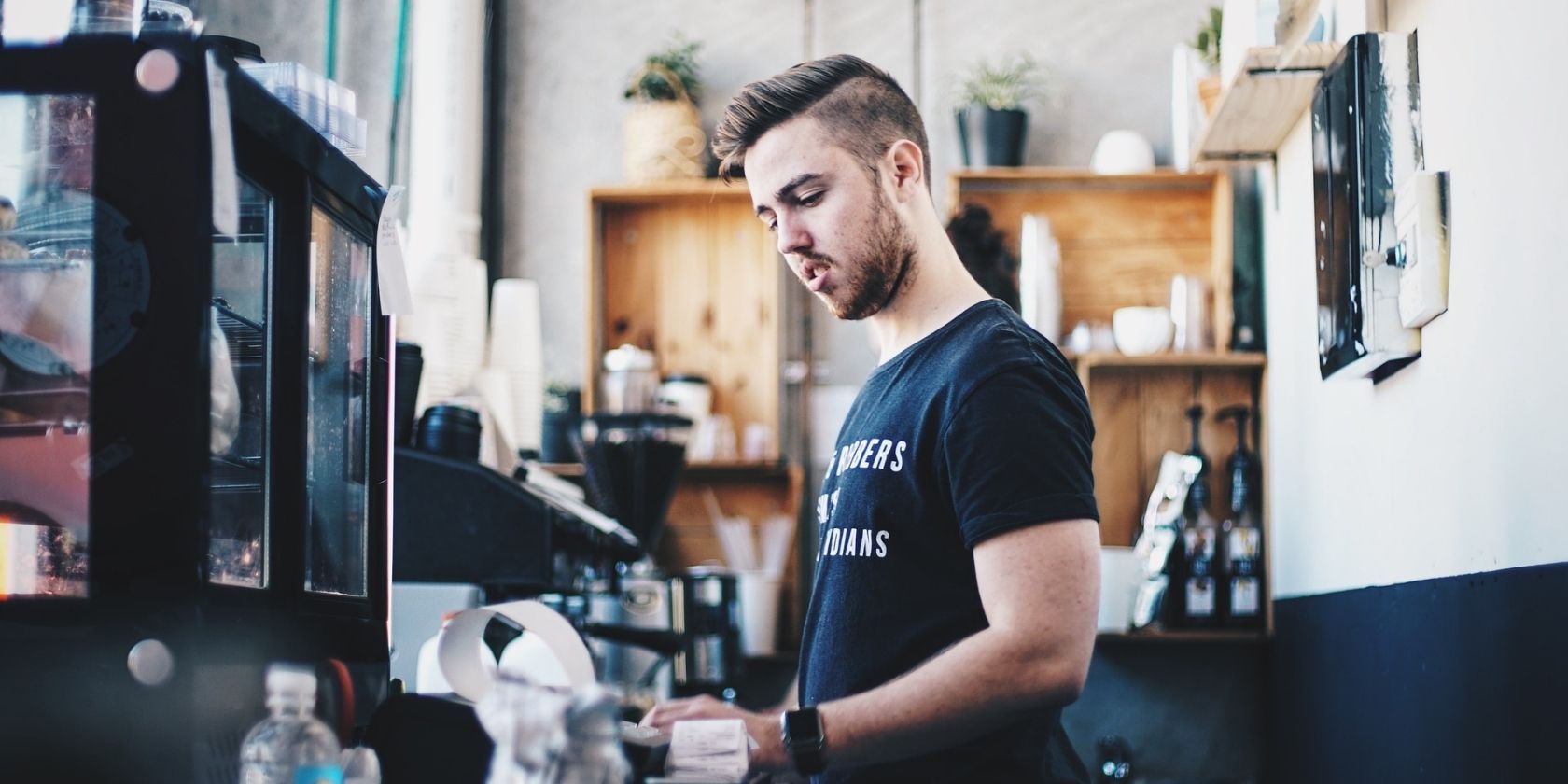 best apps to help you support local small businesses - man in a coffee shop