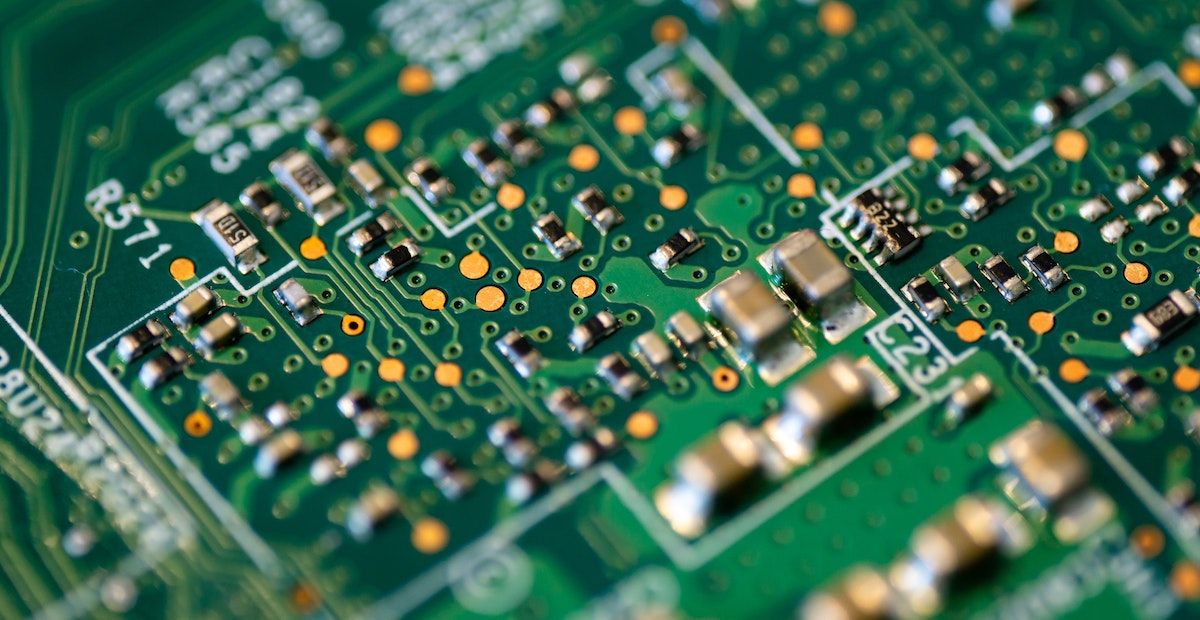 A focused photo of a green circuit board.