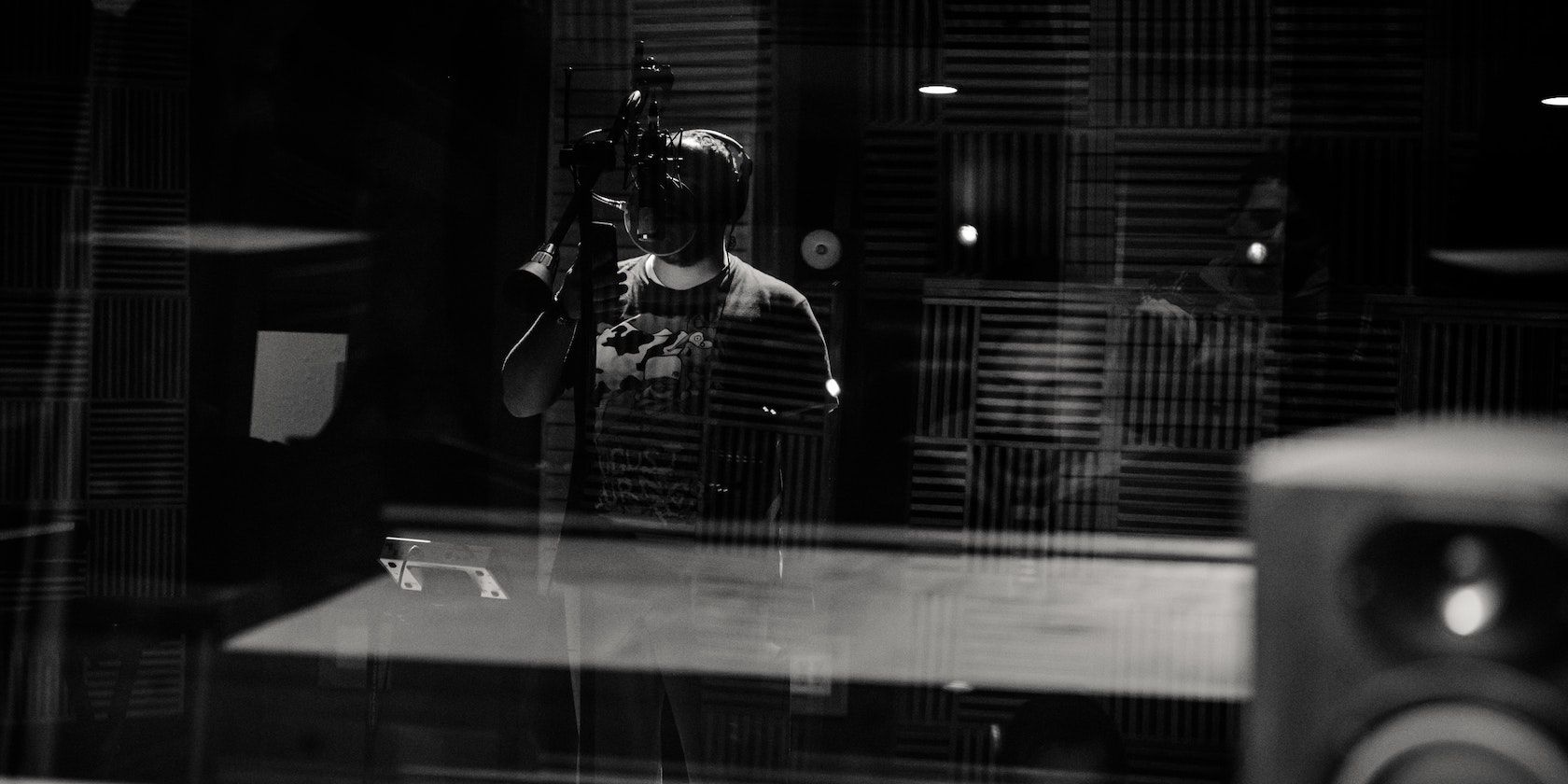 A person singing in a music studio.