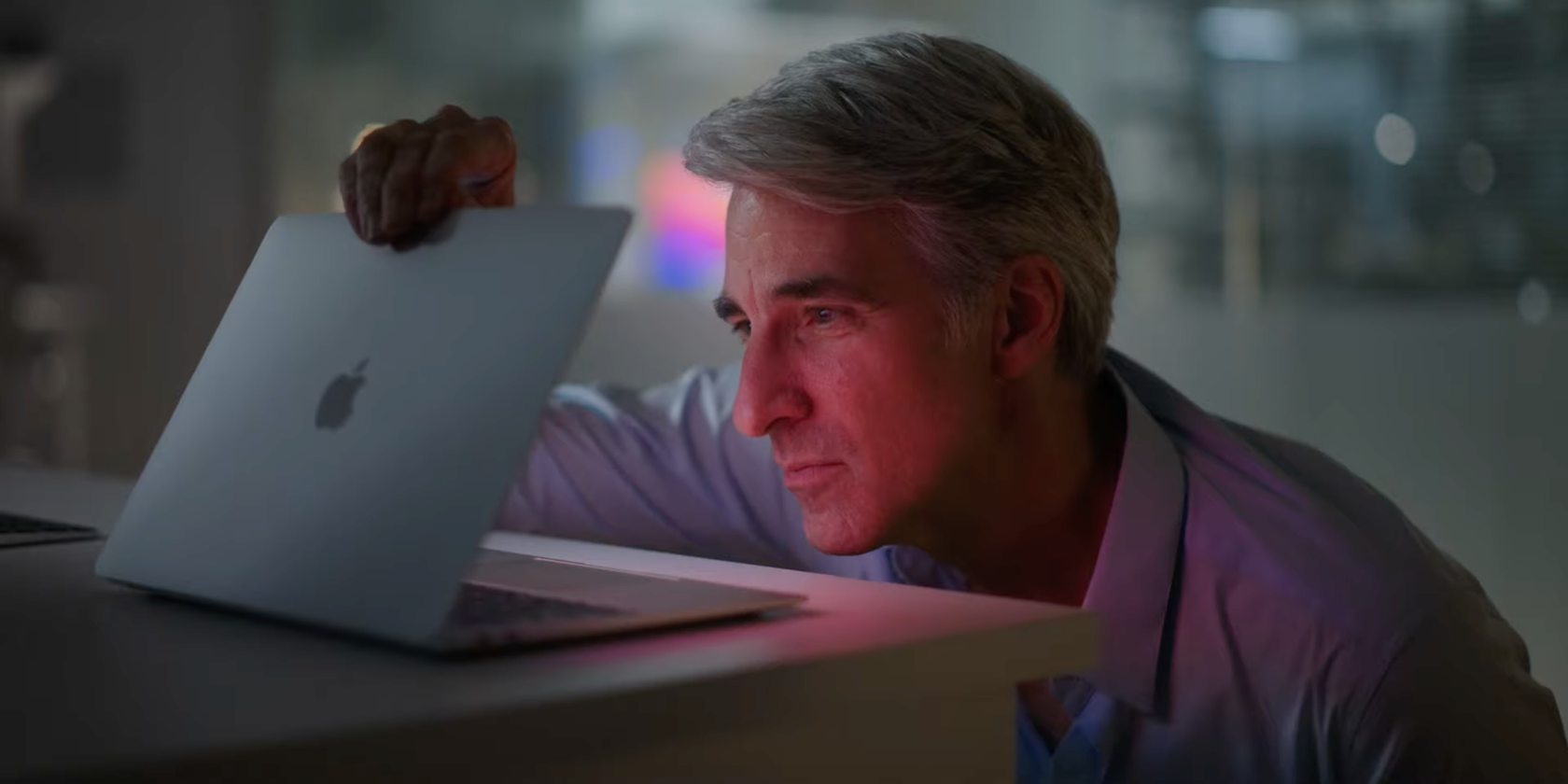 A still from the Apple October 2020 event video showing Craig Federighi, Senior Vice President of Software Engineering, opening the lid of an M1 MacBook Air notebook