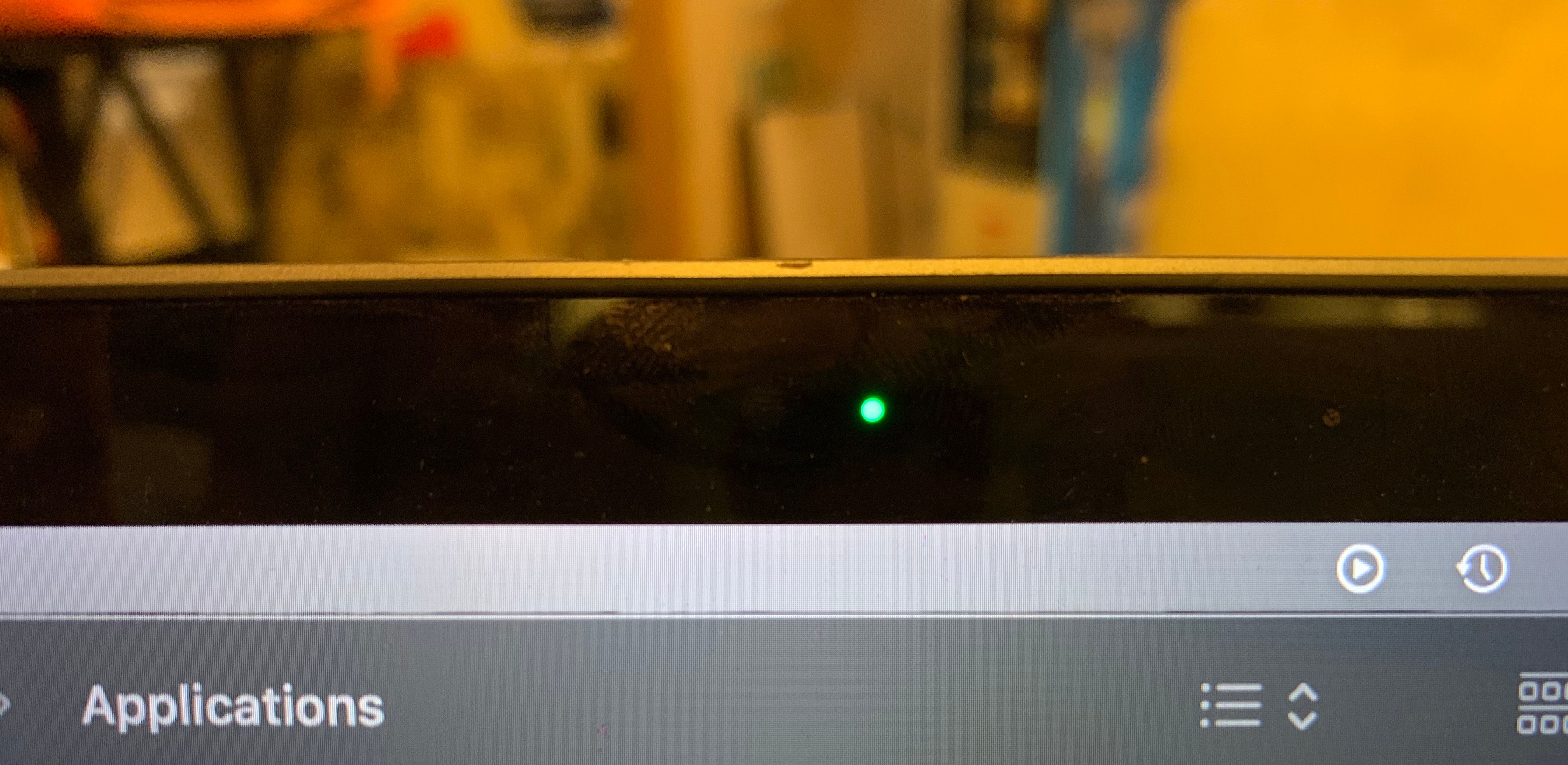 A close up of the green LED light to the right of the MacBook Pro's built-in camera