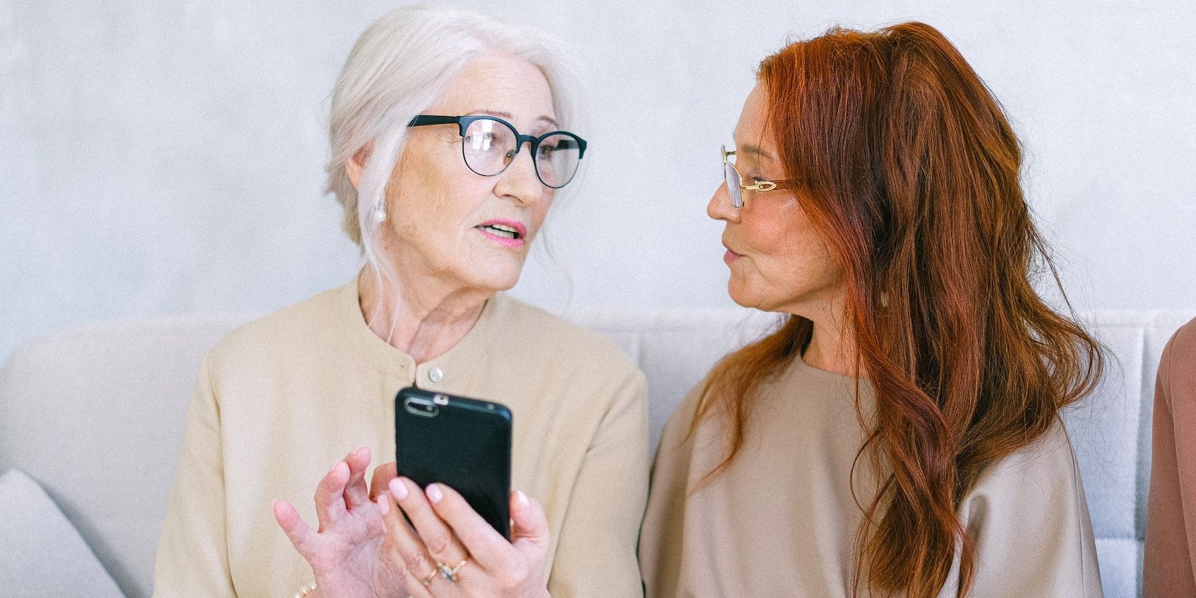 Older Lady showing smartphone to daughter
