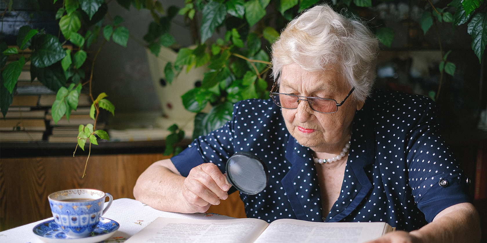 Elderly Woman Using Magnifying Glass