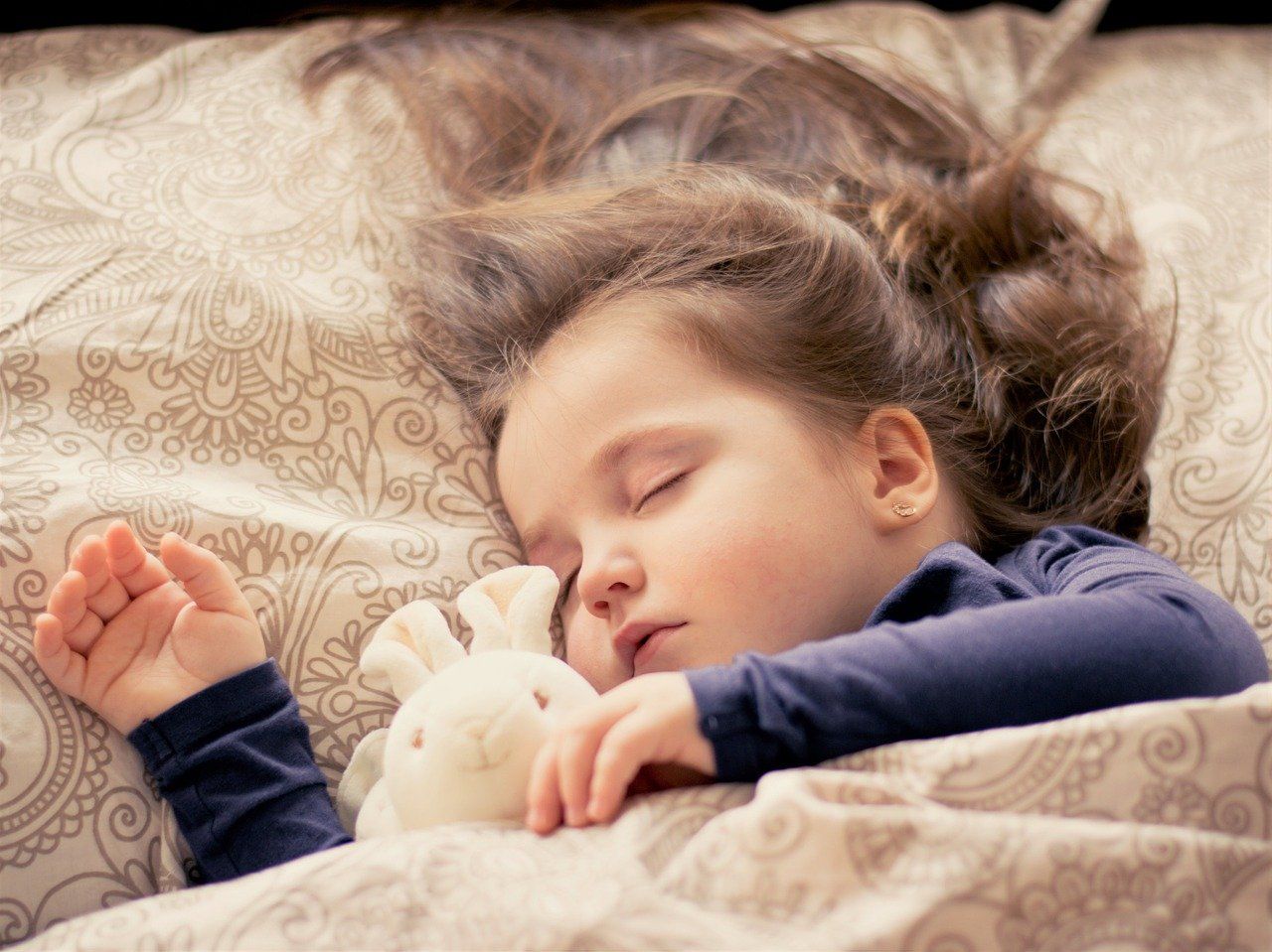 Little Girl Sleeping in Bed