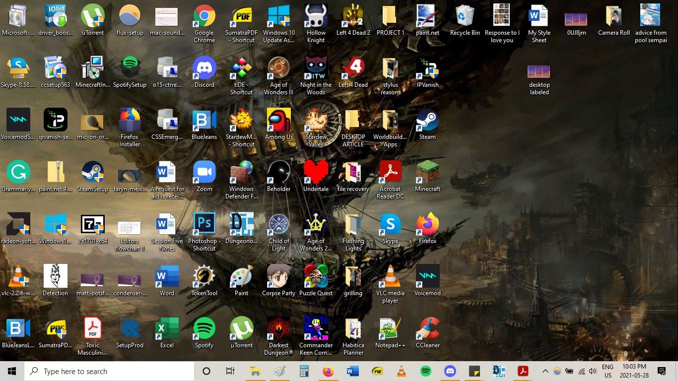 A desktop cluttered with apps, folders, photos, and documents