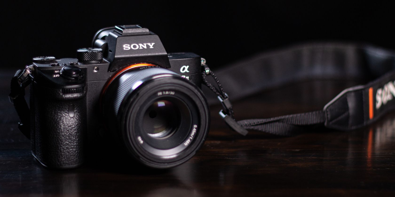 A close-up of a Sony DSLR camera with strap attached