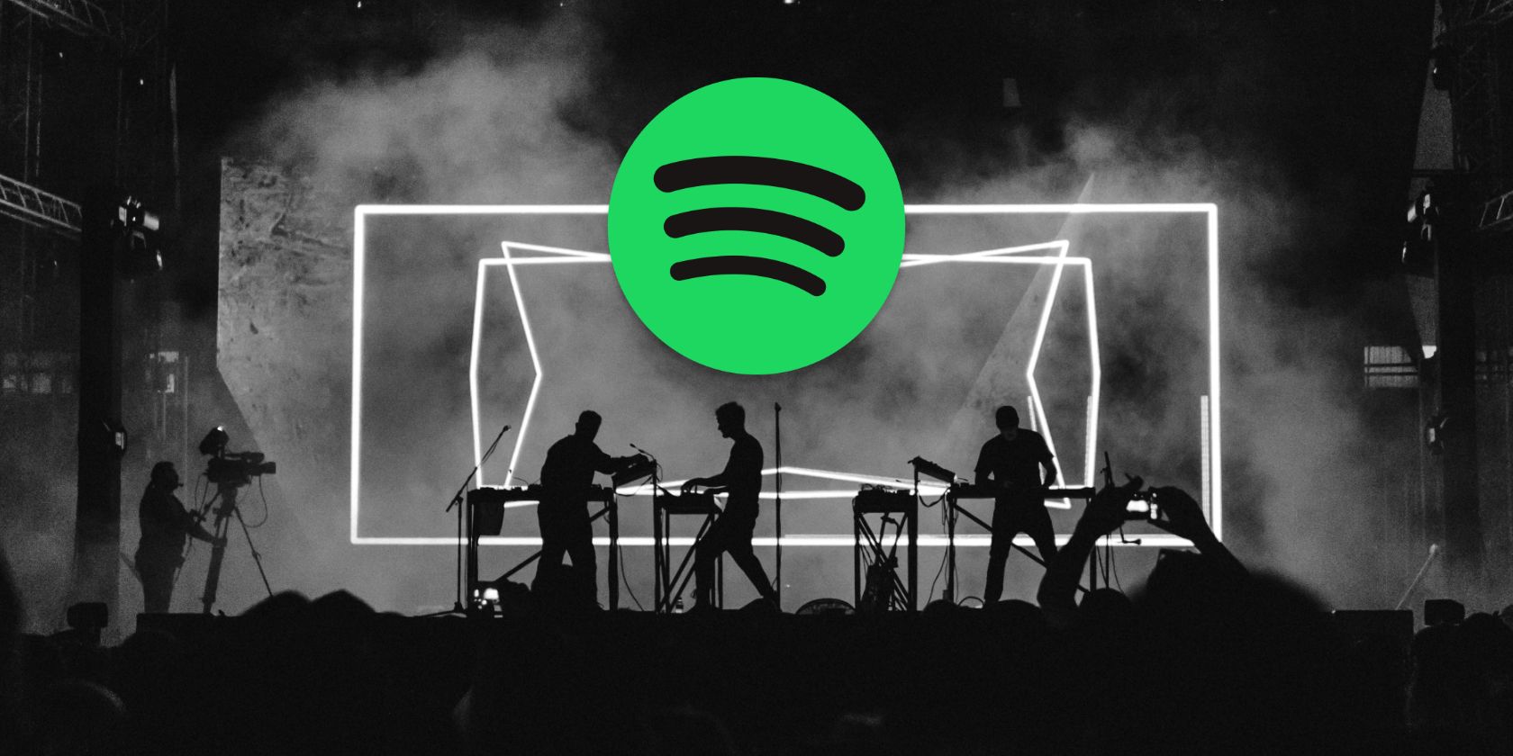 A black and white photo of a concert with the Spotify logo in the foreground.