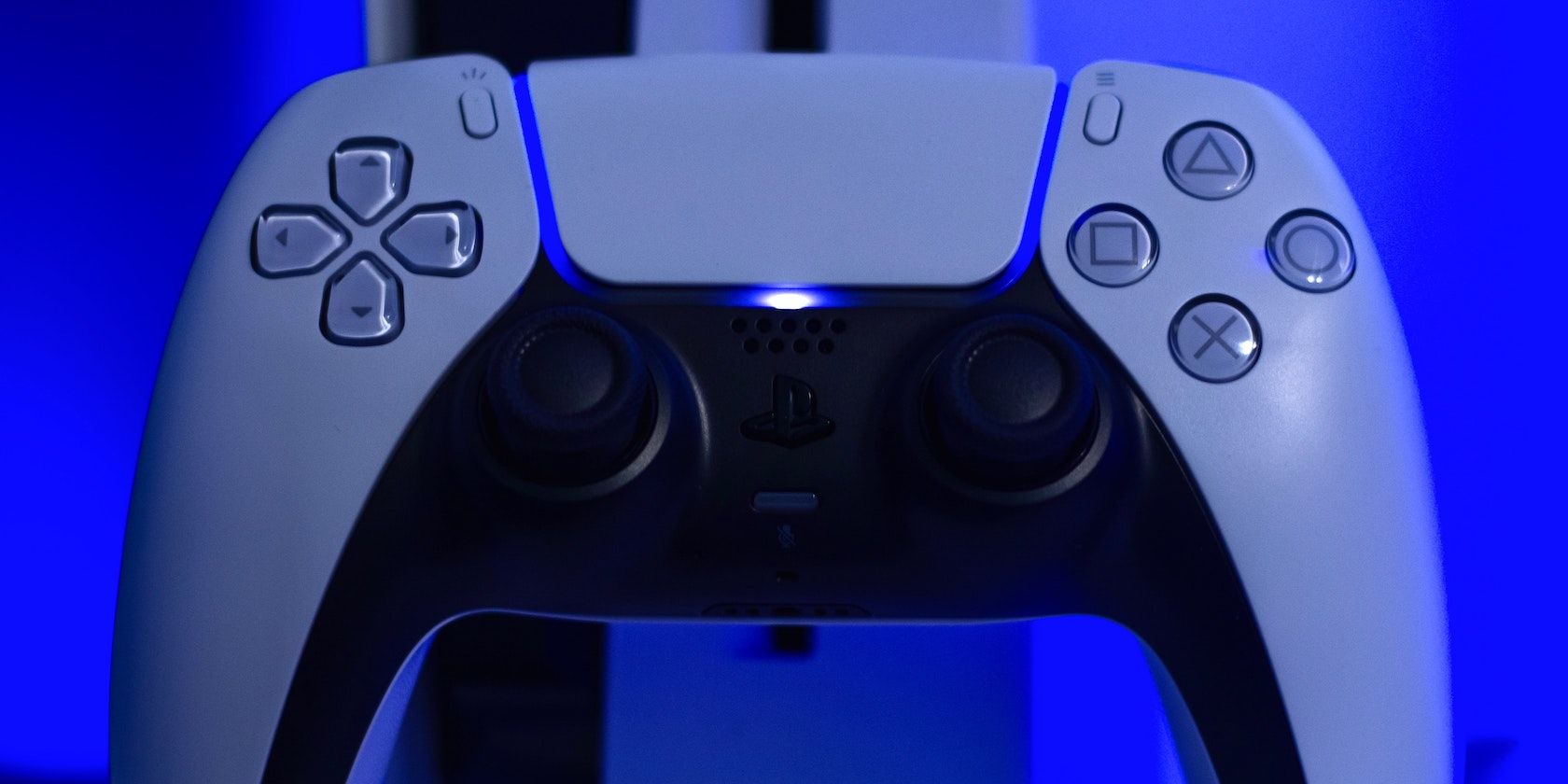 A DualSense controller in front of a PS5