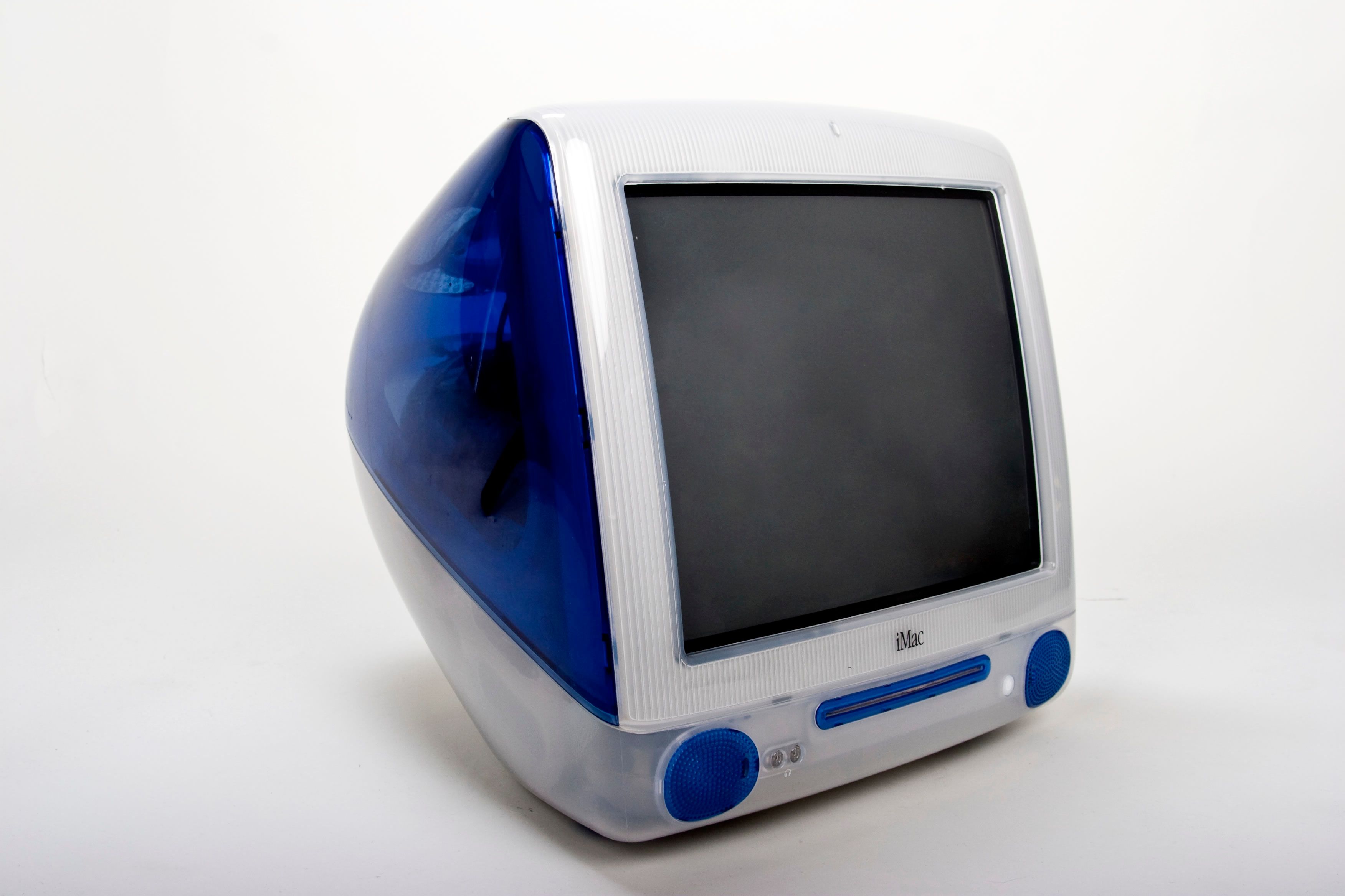 A blue iMac G3 is displayed against a white background at a 3/4 angle