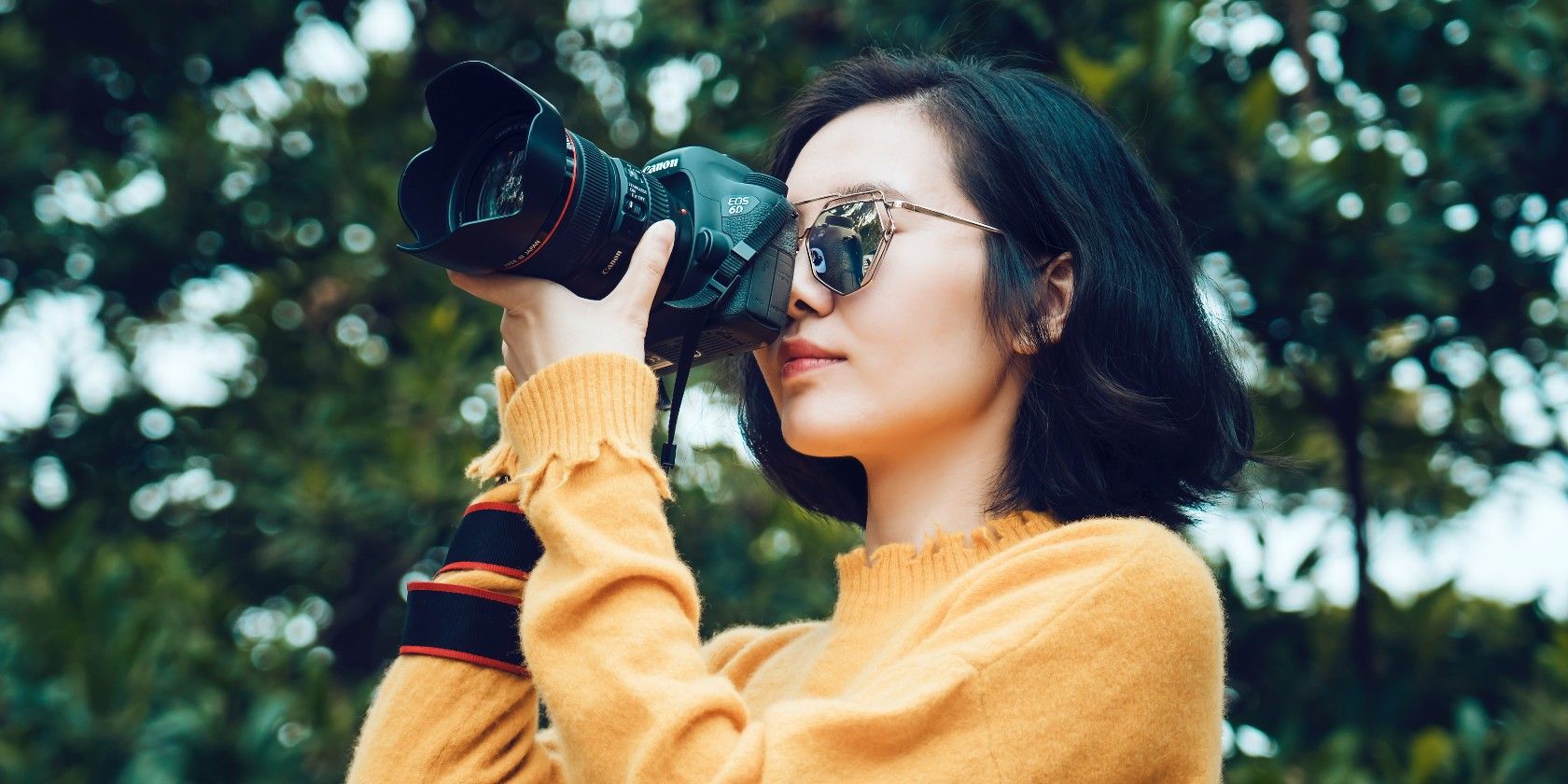 photo of woman taking photo with a camera