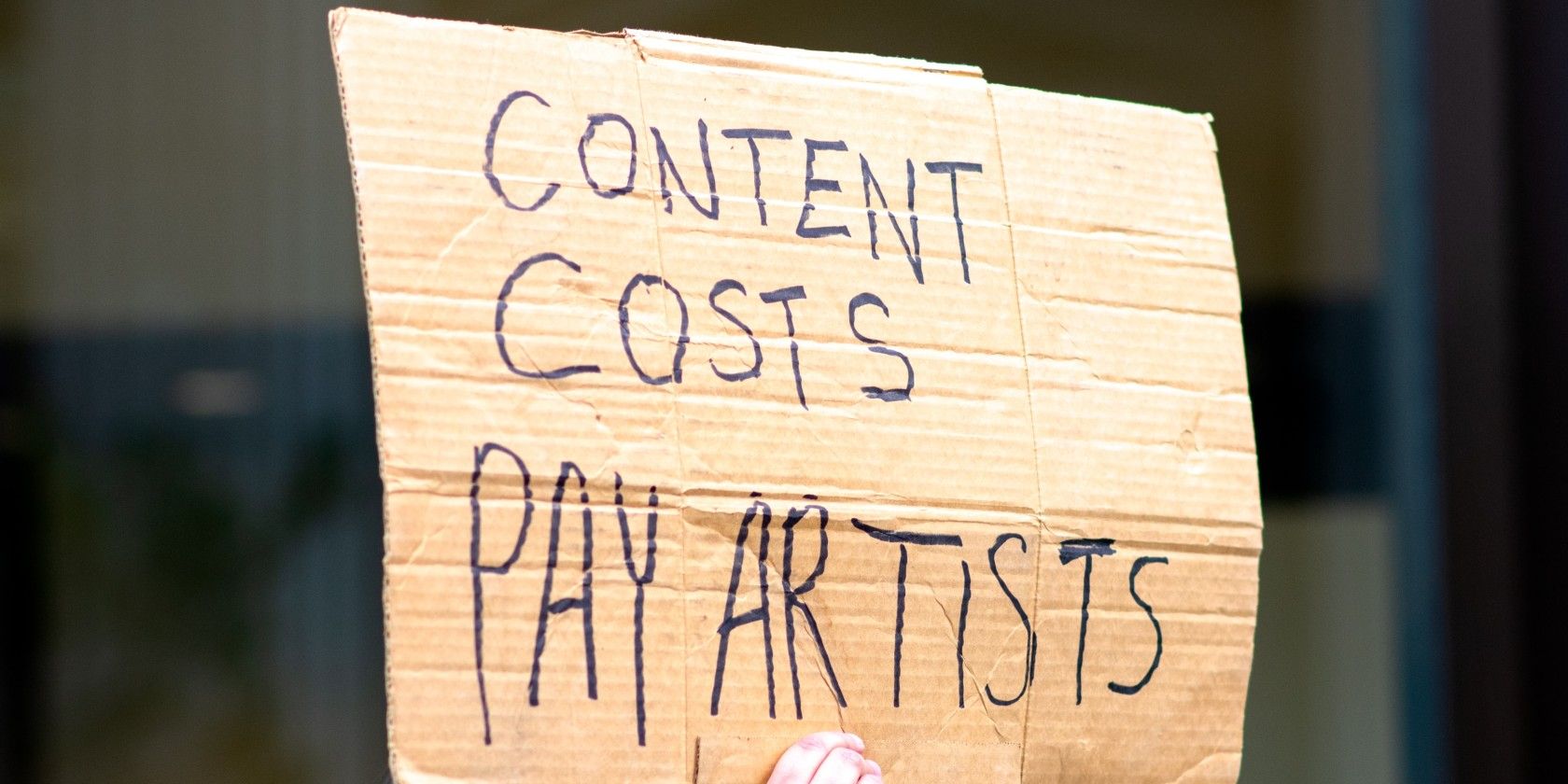 sign held at protest against music streaming service prices
