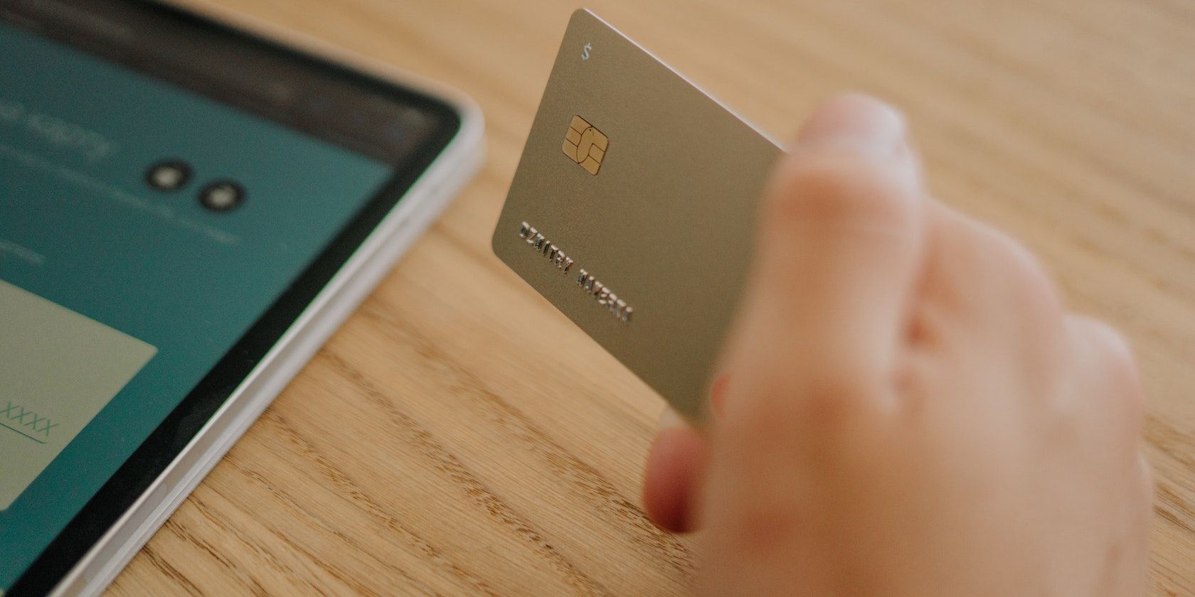 Stock image photo of a hand holding a gold credit card