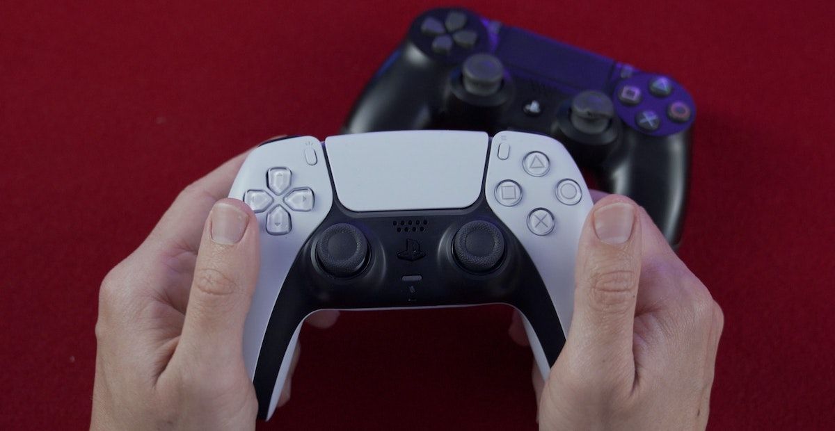 Person holding a PS5 controller